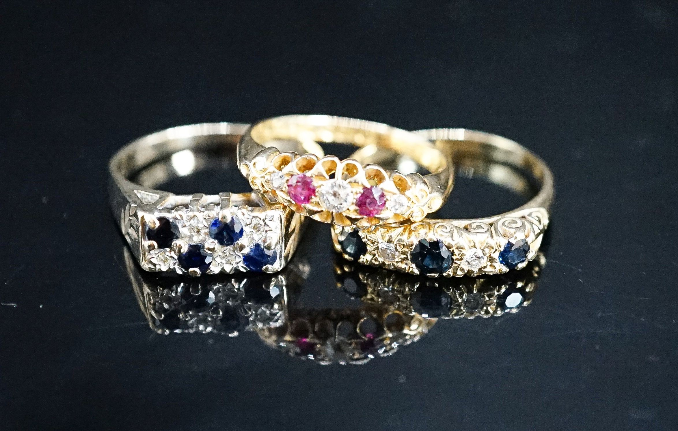 A George V 18ct gold, ruby and diamond chip five stone ring, a later similar sapphire and diamond ring gross 6.7 grams and a 9ct gem set ring, gross 4 grams.